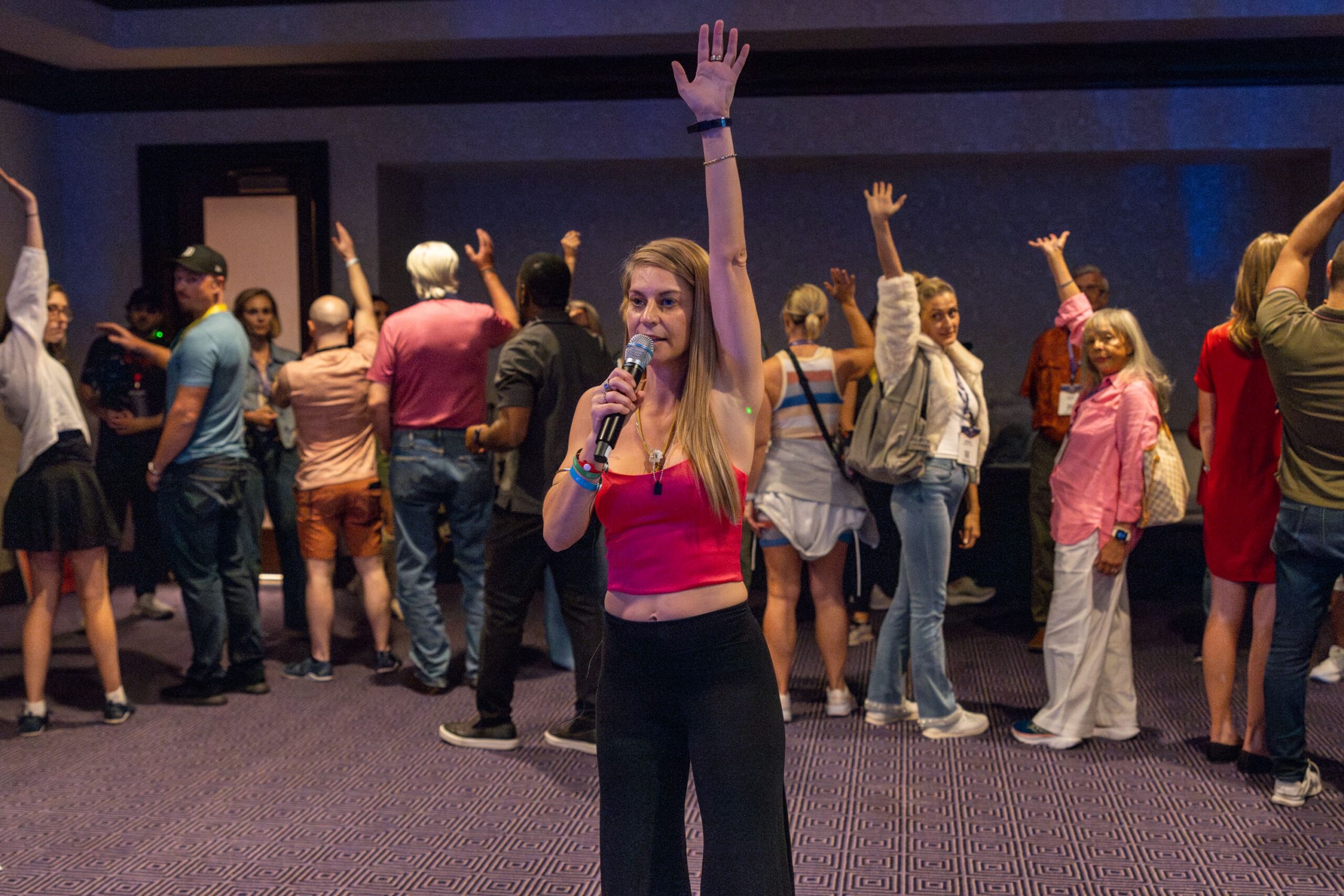 woman with hand raised talking to a group